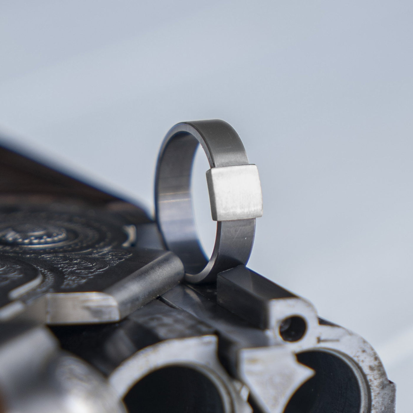 The Gunmetal 7mm Barrel Band with a silver platinum insert. The Barrel Band is the first wedding ring cut directly from a shotgun Barrel.