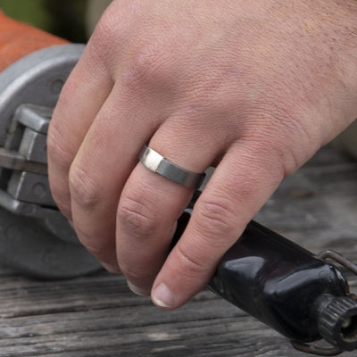 The Gunmetal 5mm Barrel Band with a silver platinum insert. The Barrel Band is the first wedding ring cut directly from a shotgun Barrel.