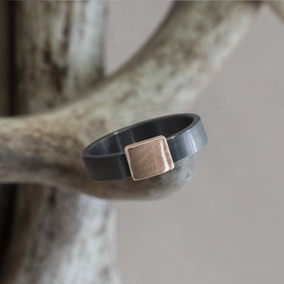 The Gunmetal 5mm Barrel Band with a rose gold insert. The Barrel Band is the first wedding ring cut directly from a shotgun Barrel.