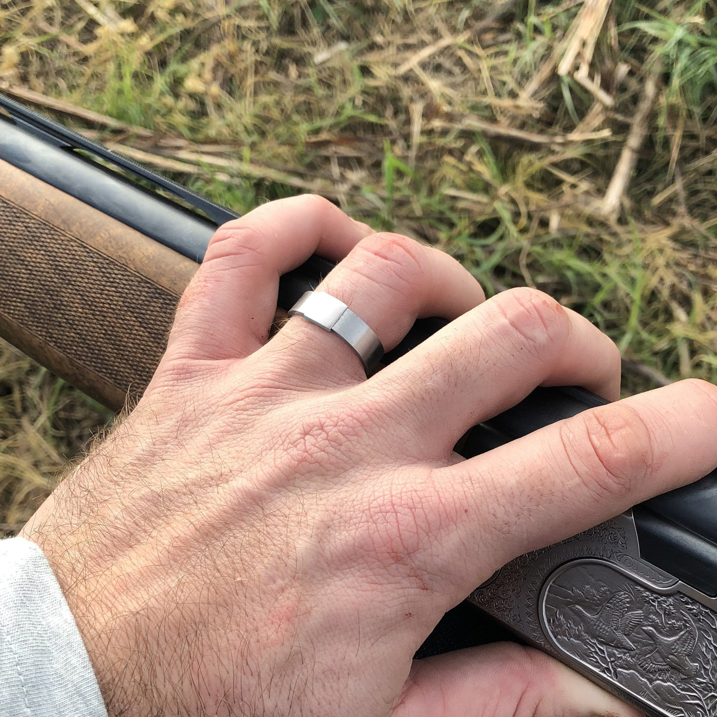 The Classic 5mm Barrel Band with a white gold insert holding a shotgun.